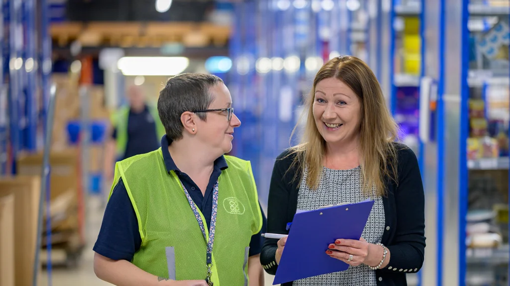 Two older women at work in a stock room