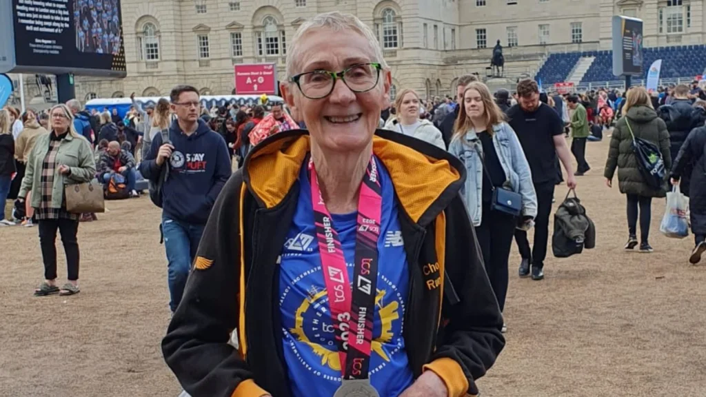 Rosemary wears a medal and smiles at the camera